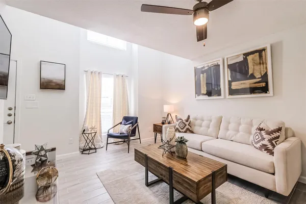 a living room with furniture a couch and chandelier