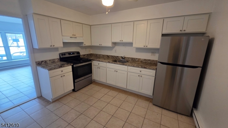12 Ghost Pony Road, Unit B Andover, NJ 07821 - Photo 2 of 10 a kitchen with a stove a sink and a refrigerator