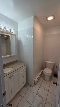 a bathroom with a toilet sink and vanity