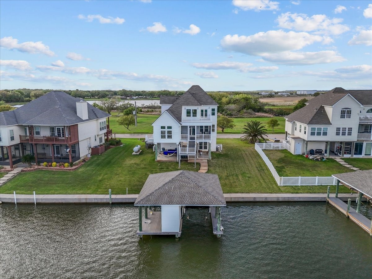 This waterfront property features a spacious backyard and a private dock. Ideal for those seeking serene views and direct water access.