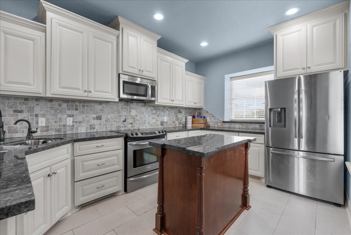 211 Tuna Run Freeport, TX 77541 - Photo 17 of 48 This spacious kitchen boasts ample storage, granite countertops and stainless steel appliances.