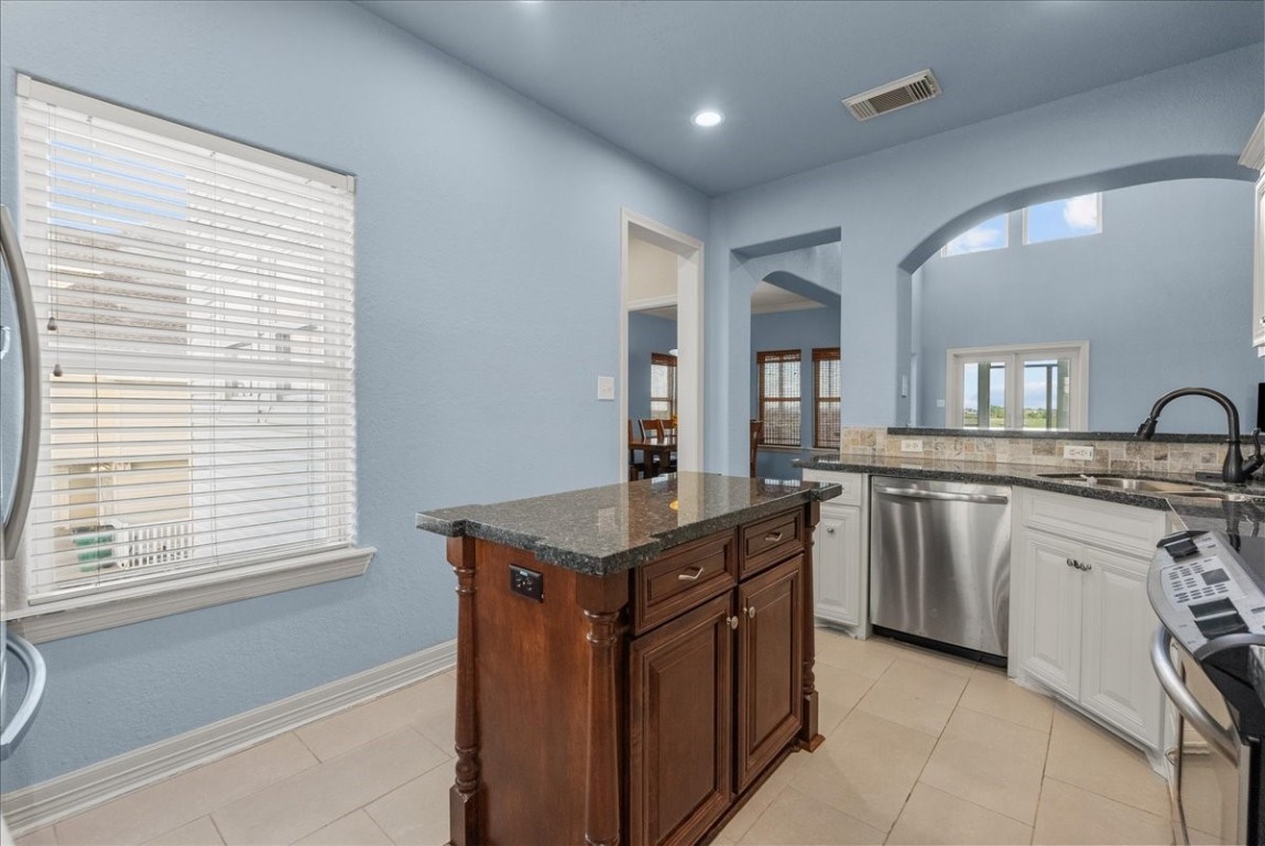 211 Tuna Run Freeport, TX 77541 - Photo 19 of 48 A butler's pantry with additional storage connect the kitchen and laundry area.