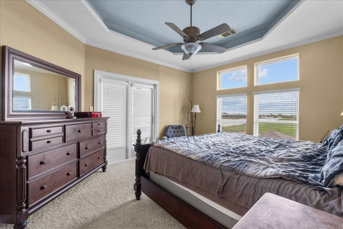 211 Tuna Run Freeport, TX 77541 - Photo 26 of 48 This primary suite features a tray ceiling, large windows offering plenty of natural light and scenic views.