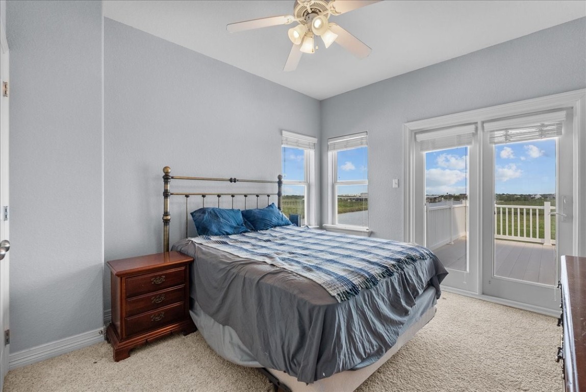 211 Tuna Run Freeport, TX 77541 - Photo 34 of 48 Bedroom 3 is upstairs with a large walk-in closet, access to a shared, connecting bathroom and private access to a third story/rooftop deck with views of the canal.