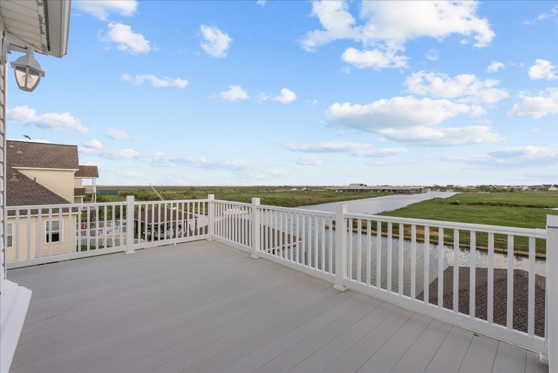 211 Tuna Run Freeport, TX 77541 - Photo 37 of 48 Spacious rooftop deck offers serene views of canal, perfect for relaxation and outdoor enjoyment. This deck is accessed through bedroom 3.