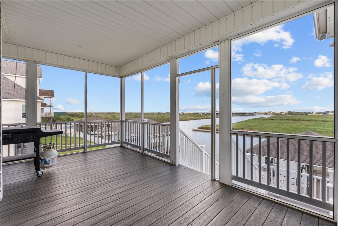 211 Tuna Run Freeport, TX 77541 - Photo 38 of 48 This screened porch offers a serene view of the canal, perfect for enjoying the outdoors in comfort.