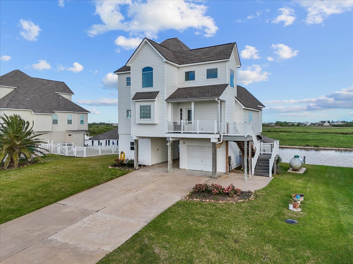 211 Tuna Run Freeport, TX 77541 - Photo 4 of 48 This is a charming, home features a spacious driveway and a well-maintained lawn, perfect for enjoying scenic views. The property is adjacent to a canal, offering water access.