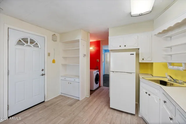 a view of a kitchen with a refrigerator and a stove