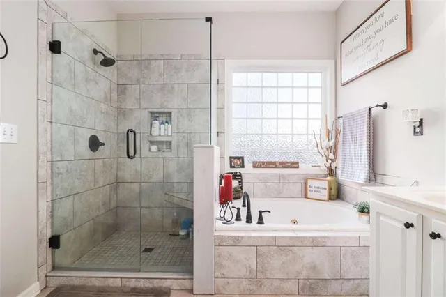 a bathroom with a bathtub and a shower