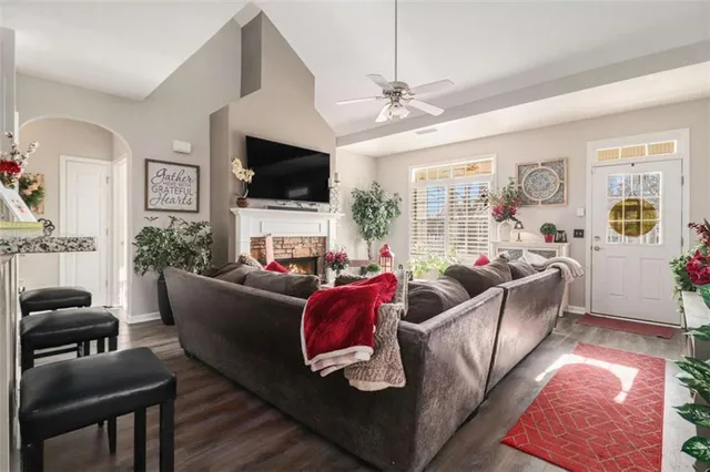 a living room with furniture a flat screen tv and a fireplace