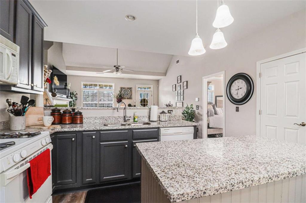 2685 Mariner Way Villa Rica, GA 30180 - Photo 9 of 26 a kitchen with stainless steel appliances granite countertop a stove and a wooden cabinets
