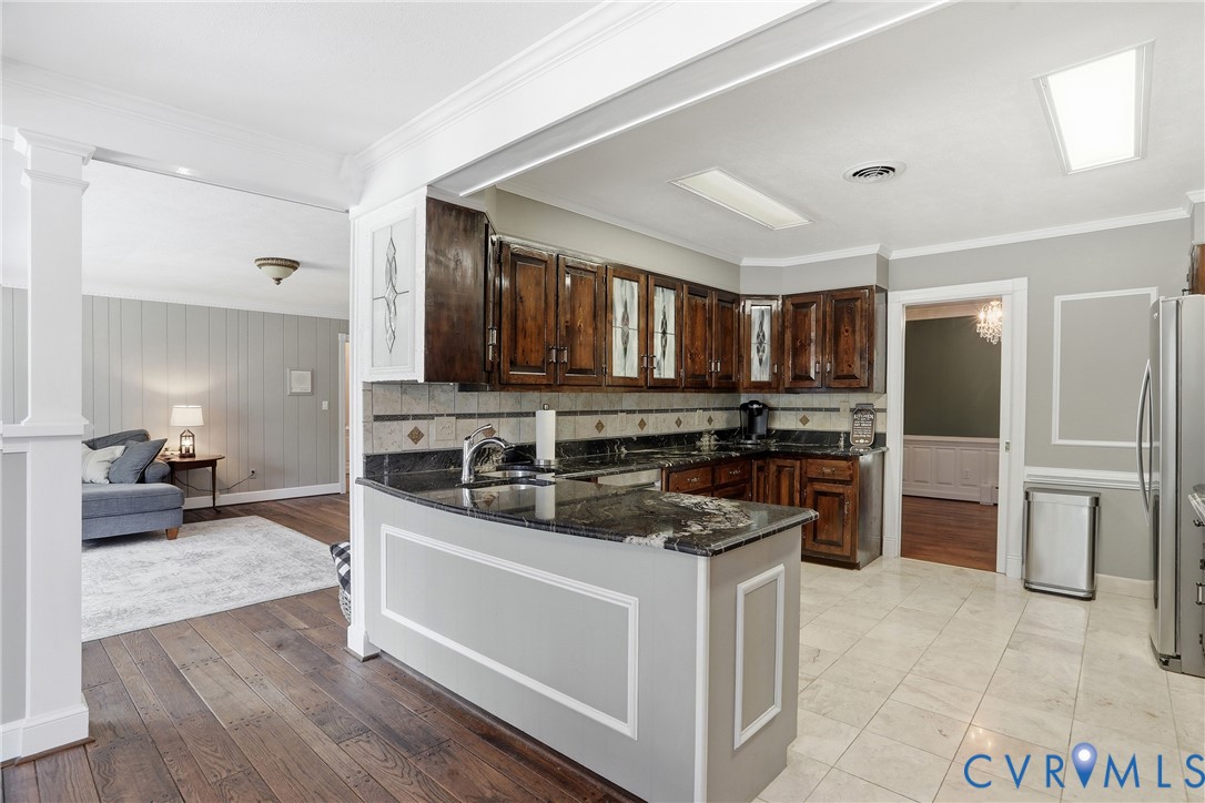 13300 West Patrick Henry Road Doswell, VA 23047 - Photo 13 of 69 Kitchen featuring dark wood cabinetry, granite cou