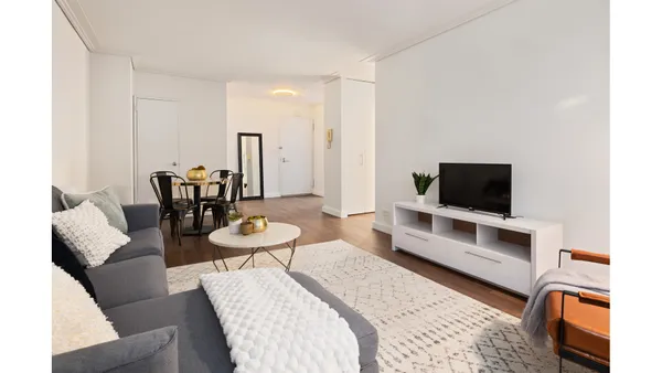a hotel room with furniture and a flat screen tv