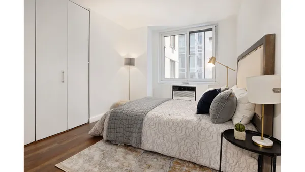 a bedroom with furniture and a window