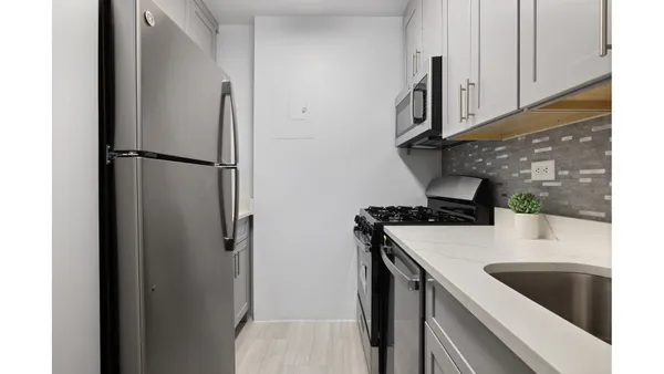 a kitchen with a sink and a refrigerator