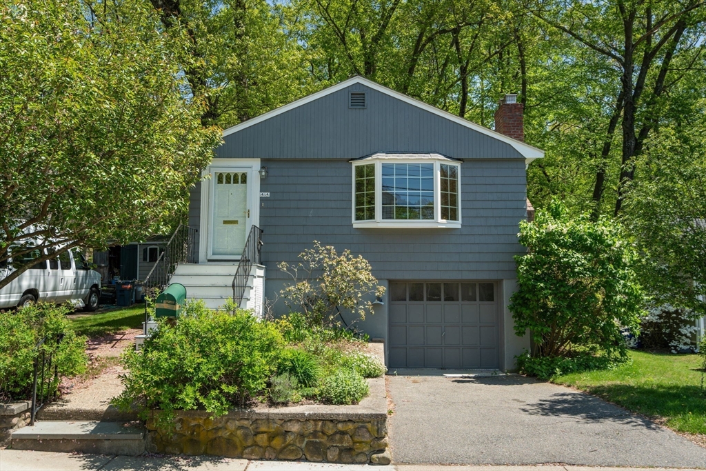 44 Hackensack Road Chestnut Hill, MA 02467 - Photo 1 of 13 a front view of a house with garden