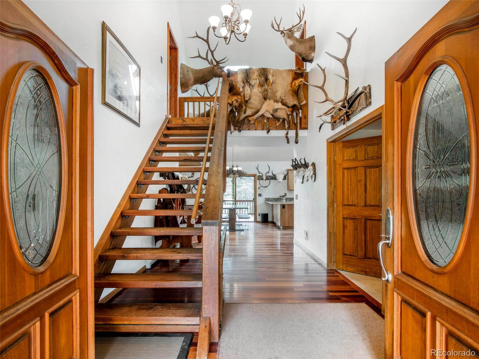 503 Conestoga Road Bailey, CO 80421 - Photo 11 of 40 a view of entryway with wooden floor and mirror