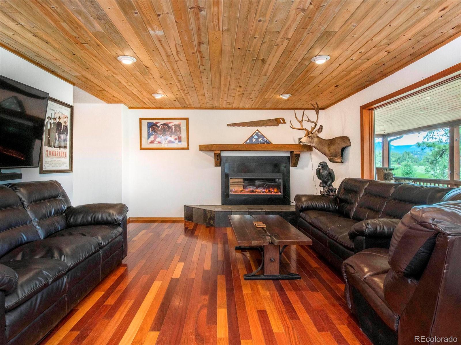 503 Conestoga Road Bailey, CO 80421 - Photo 19 of 40 a living room with furniture and a fireplace