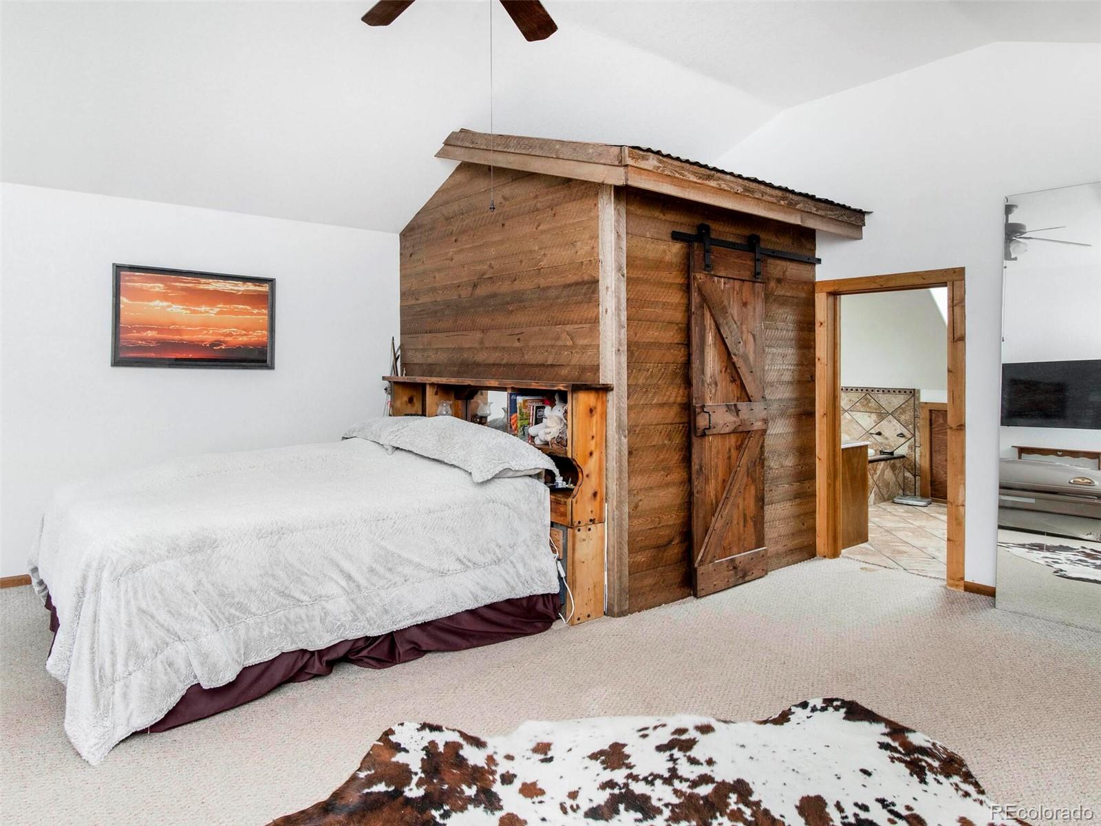 503 Conestoga Road Bailey, CO 80421 - Photo 21 of 40 a bedroom with bed and walk in closet