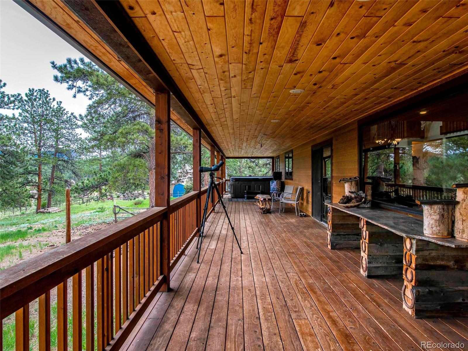 503 Conestoga Road Bailey, CO 80421 - Photo 32 of 40 a view of a patio with wooden floor and iron stairs