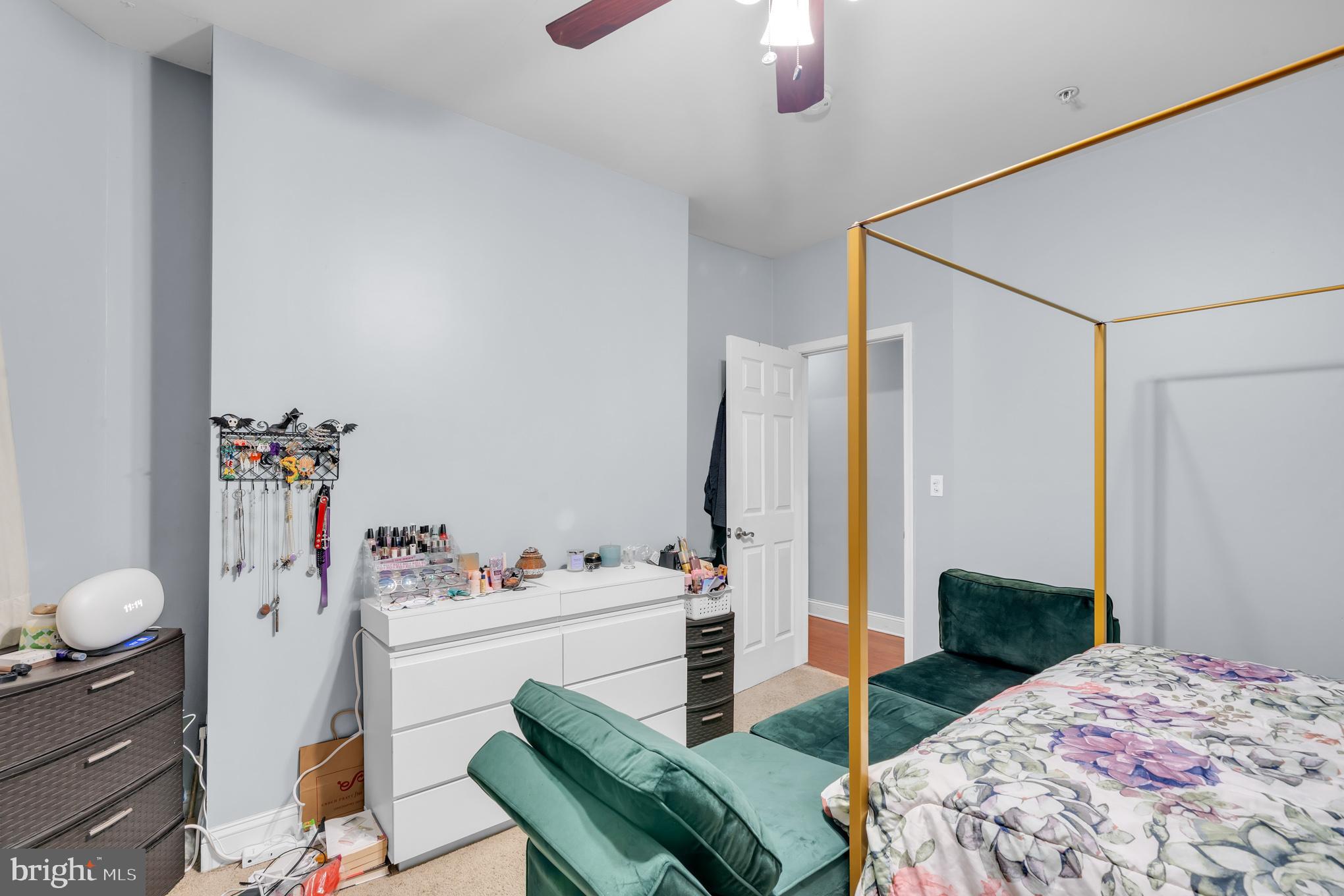 2210 North Charles Street Baltimore, MD 21218 - Photo 20 of 31 a bedroom with a bed and a chandelier