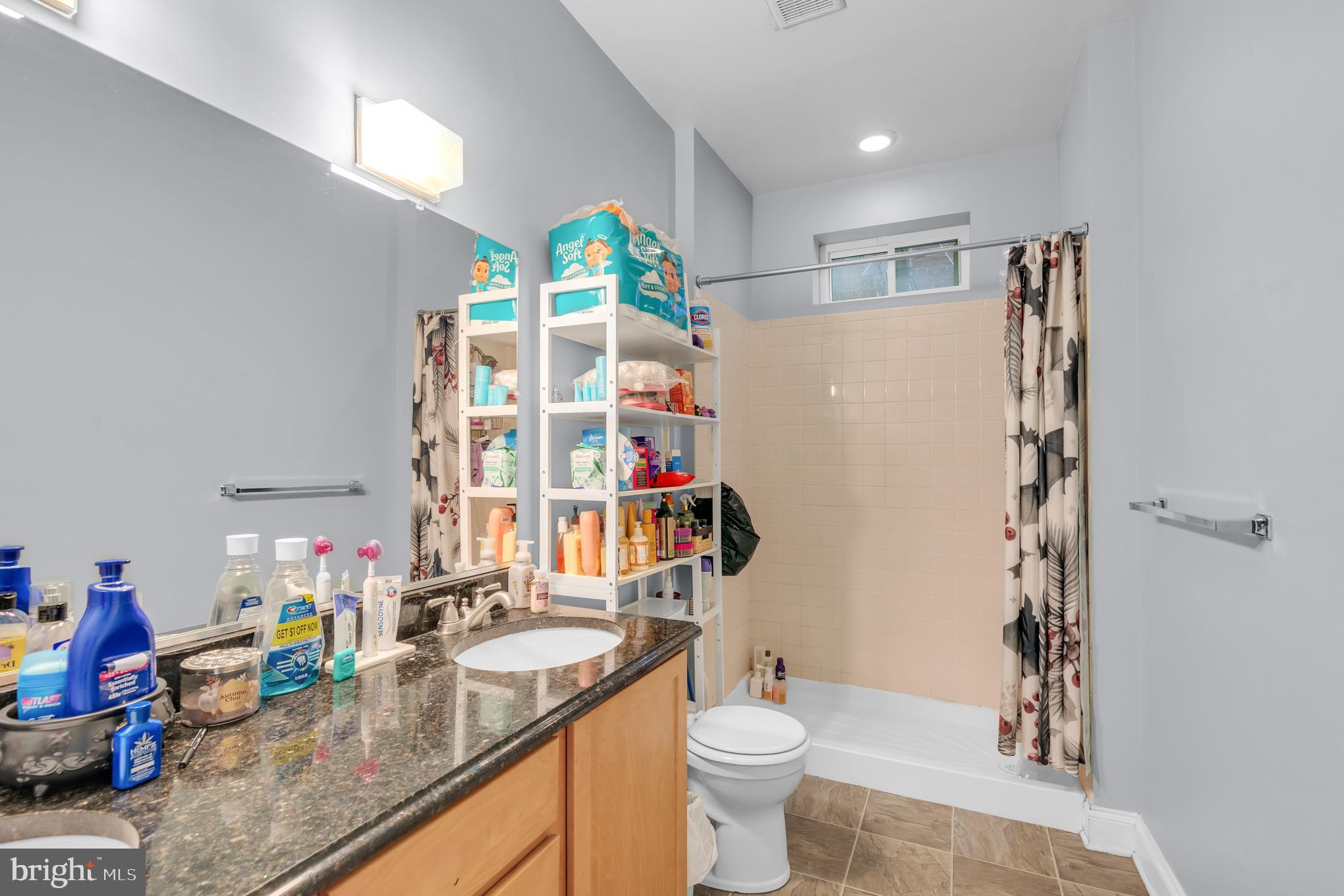 2210 North Charles Street Baltimore, MD 21218 - Photo 21 of 31 a bathroom with a granite countertop sink a toilet and shower