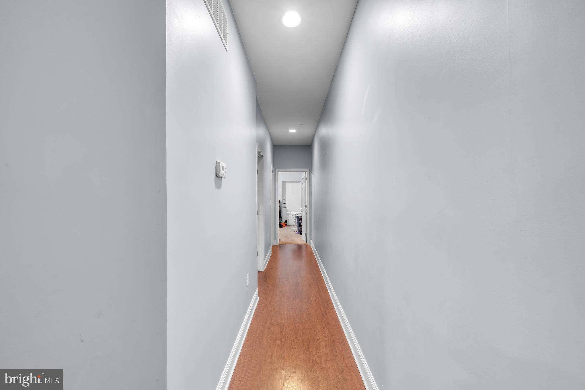 2210 North Charles Street Baltimore, MD 21218 - Photo 22 of 31 a view of a hallway with wooden floor