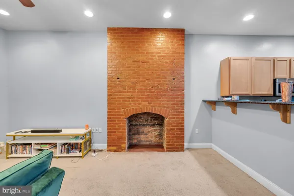 a living room with furniture and a fireplace