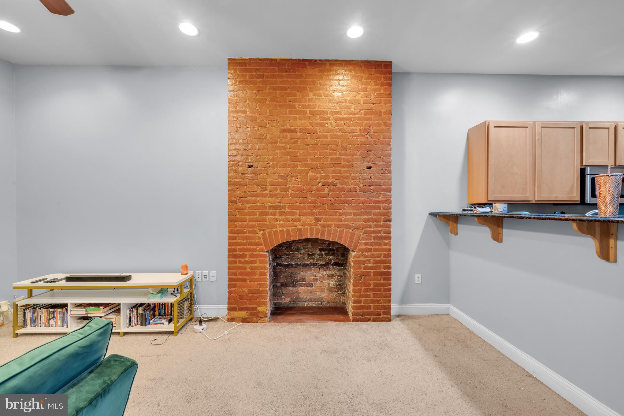 2210 North Charles Street Baltimore, MD 21218 - Photo 26 of 31 a living room with furniture and a fireplace