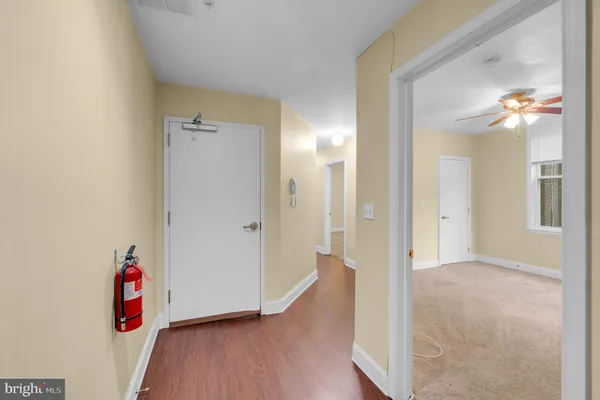 a view of an entryway with wooden floor