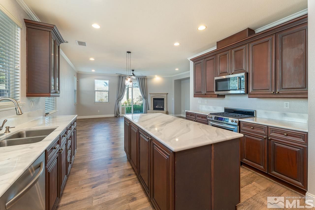 a kitchen with a stove sink and cabinets