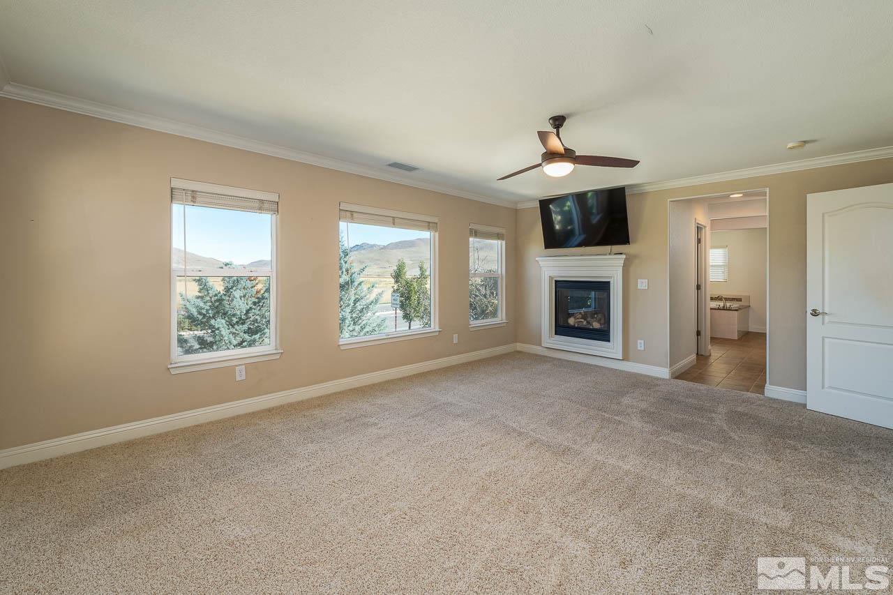1935 Angel Ridge Drive Reno, NV 89521 - Photo 18 of 33 an empty room with fireplace cabinet and windows