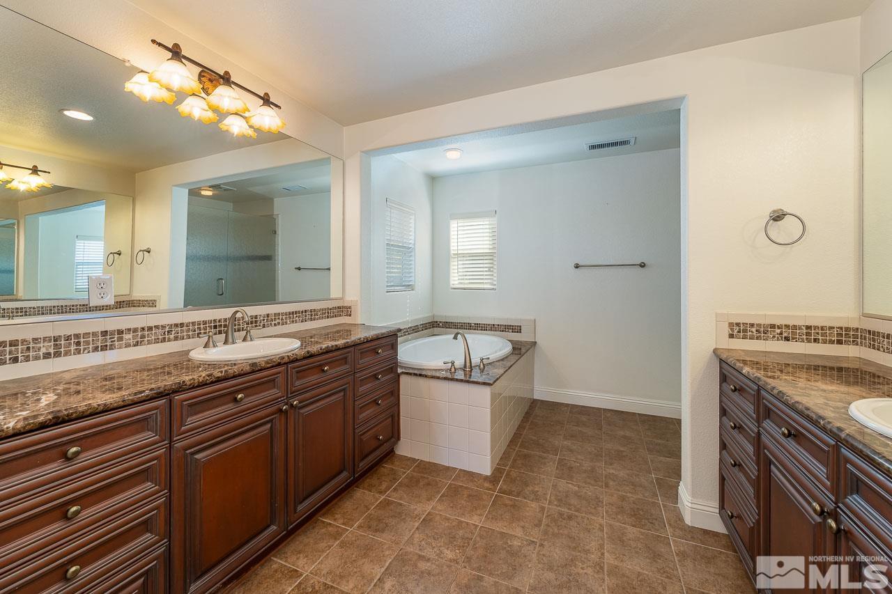1935 Angel Ridge Drive Reno, NV 89521 - Photo 20 of 33 a bathroom with a granite countertop double vanity sink and a mirror
