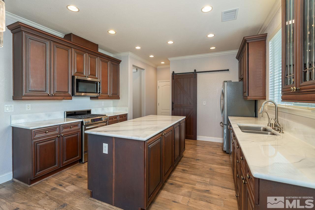 1935 Angel Ridge Drive Reno, NV 89521 - Photo 2 of 33 a kitchen with stainless steel appliances granite countertop a stove top oven a sink and a refrigerator