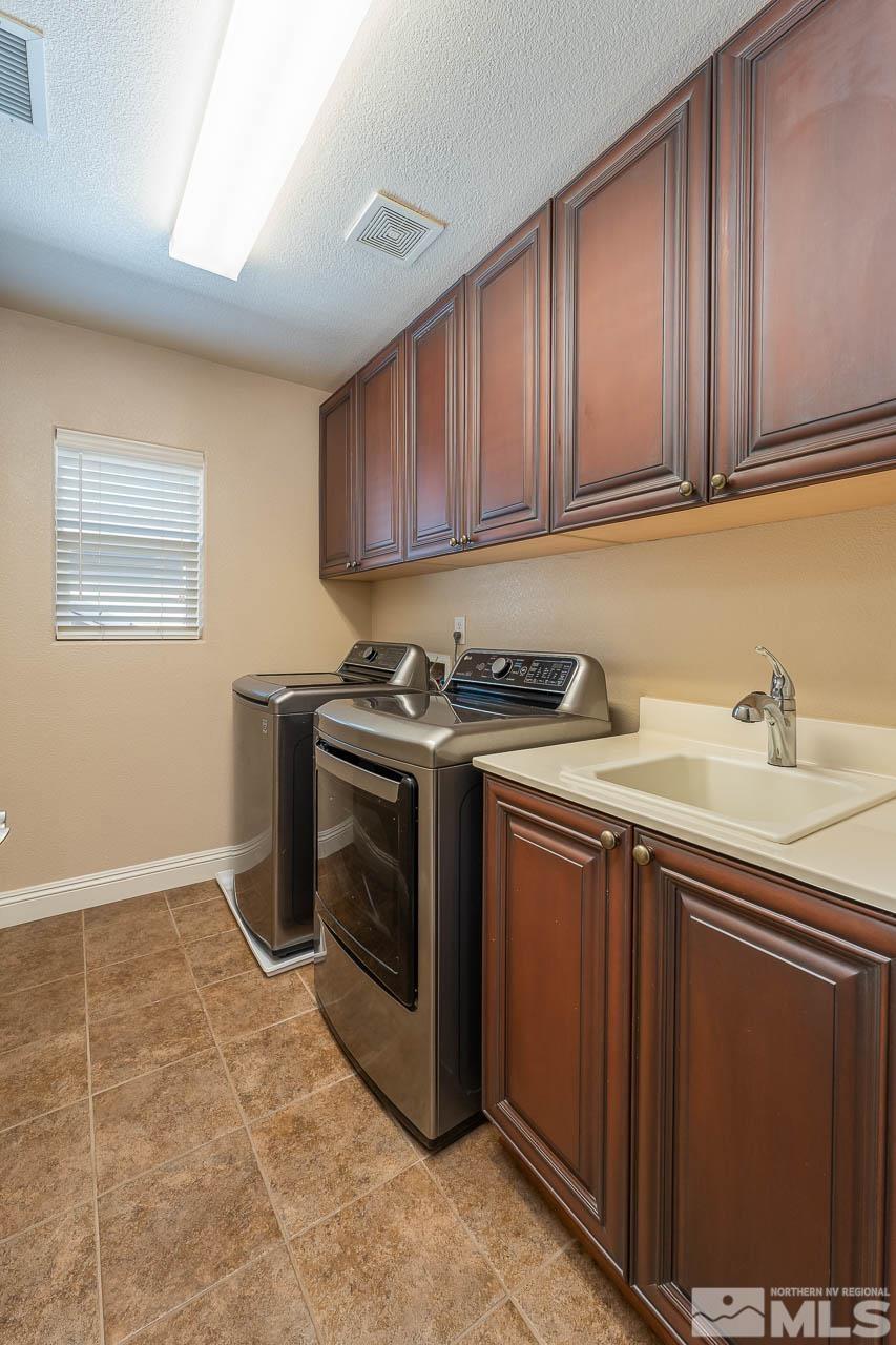 1935 Angel Ridge Drive Reno, NV 89521 - Photo 28 of 33 a kitchen with stainless steel appliances granite countertop a sink stove and cabinets