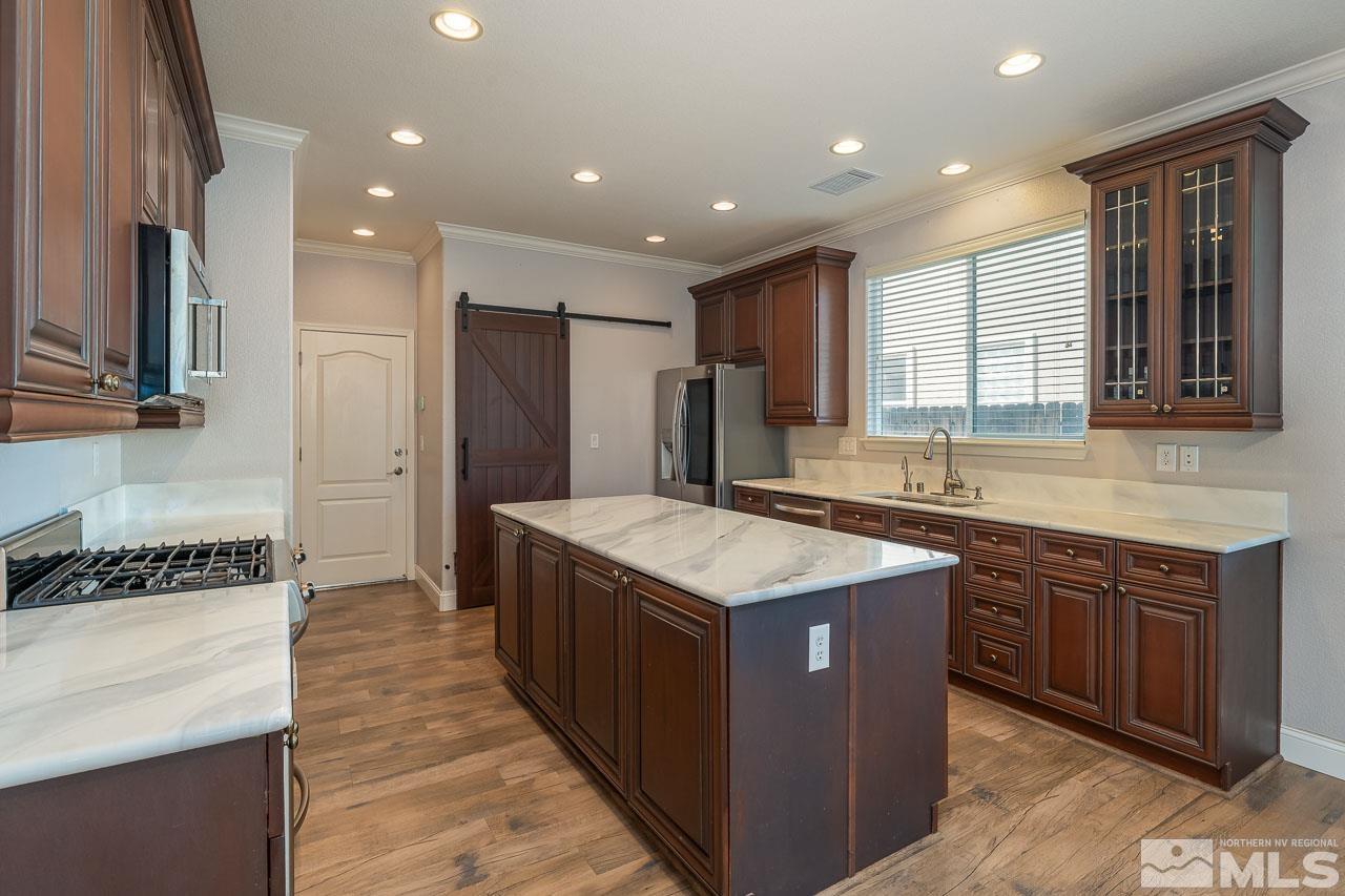 1935 Angel Ridge Drive Reno, NV 89521 - Photo 3 of 33 a kitchen with kitchen island granite countertop a sink and a refrigerator