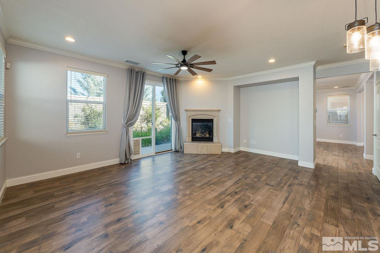 1935 Angel Ridge Drive Reno, NV 89521 - Photo 4 of 33 an empty room with wooden floor fireplace and windows