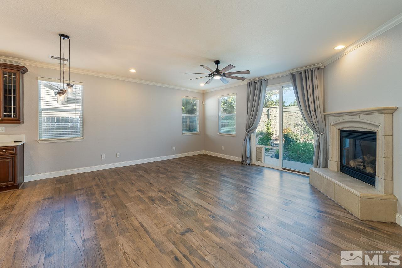 1935 Angel Ridge Drive Reno, NV 89521 - Photo 5 of 33 a view of an empty room with wooden floor fireplace and a window