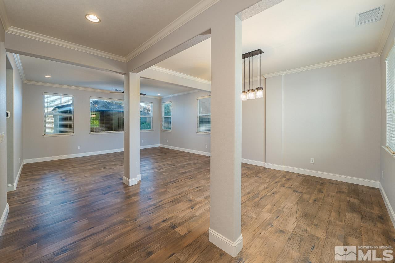 1935 Angel Ridge Drive Reno, NV 89521 - Photo 6 of 33 an empty room with wooden floor and mirror
