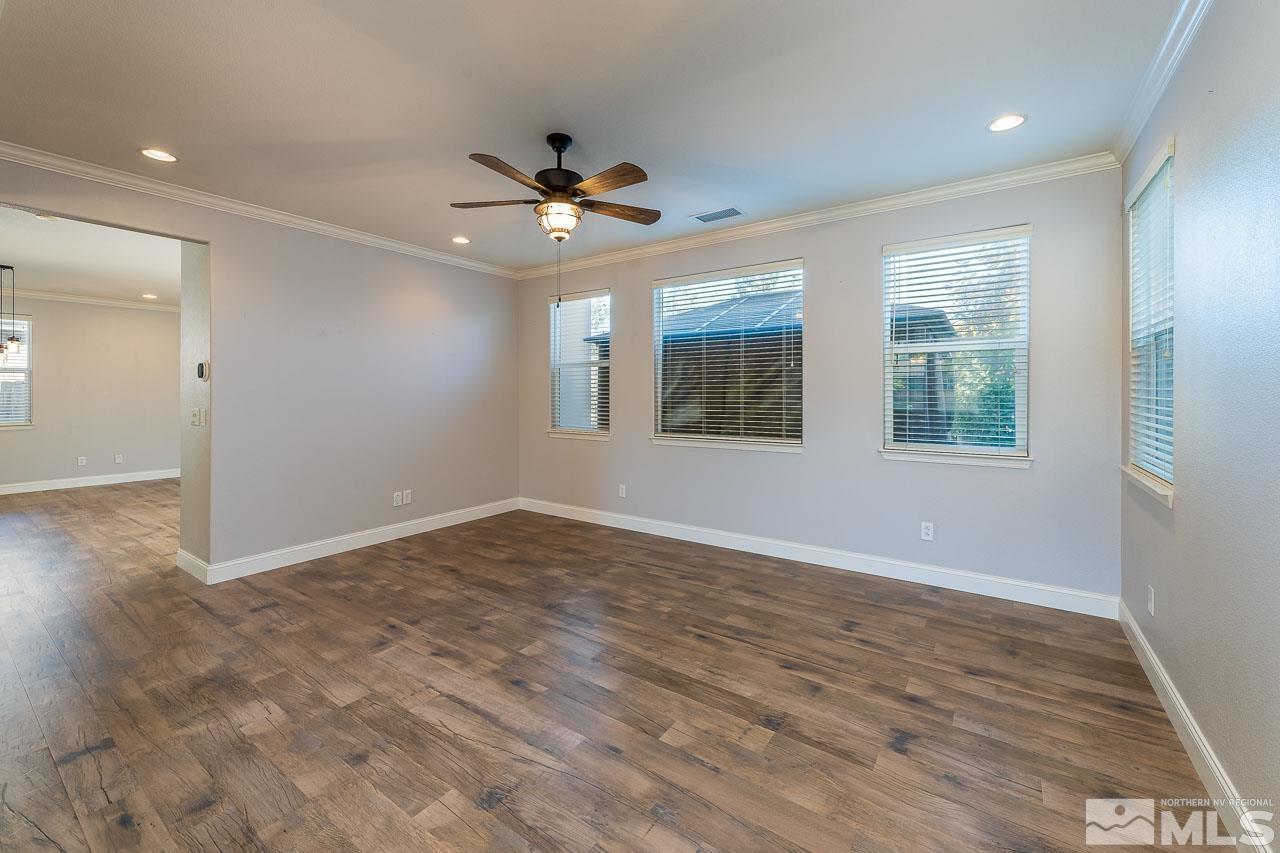 1935 Angel Ridge Drive Reno, NV 89521 - Photo 7 of 33 an empty room with wooden floor fan and windows