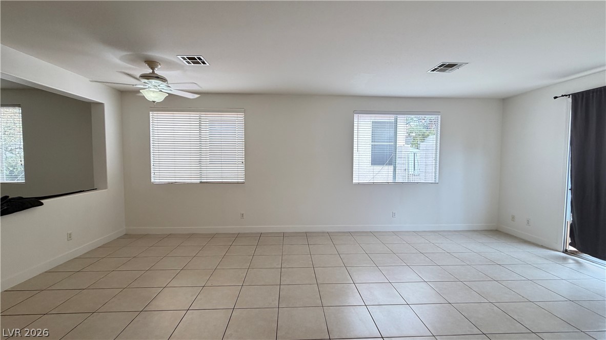 9708 Ridgebluff Avenue Las Vegas, NV 89148 - Photo 10 of 11 Tiled flooring and large windows create an open, airy feel in this versatile living space.