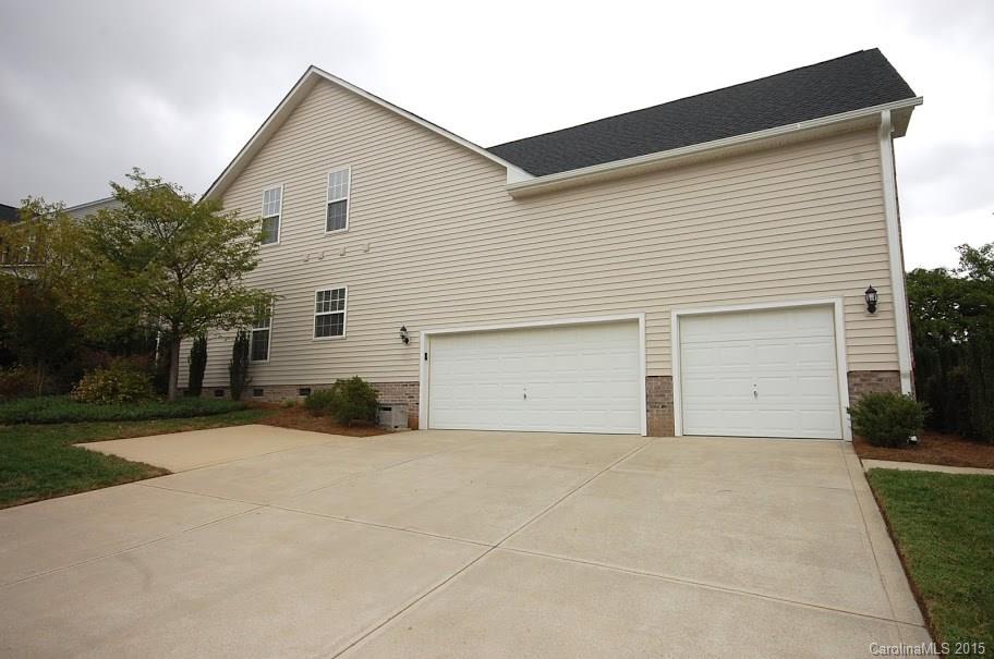 2361 Harvester Avenue, Unit 137 Fort Mill, SC 29708 - Photo 22 of 24 a front view of a house with a yard and garage
