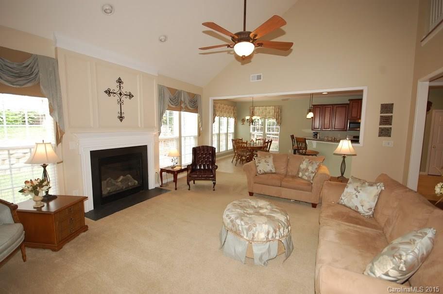 2361 Harvester Avenue, Unit 137 Fort Mill, SC 29708 - Photo 8 of 24 a living room with furniture a fireplace and a large window