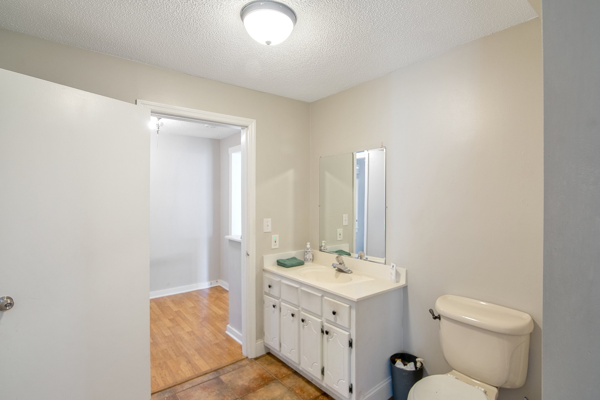 12252 Karo Road Bell Buckle, TN 37020 - Photo 19 of 25 a bathroom with a double vanity sink toilet and mirror