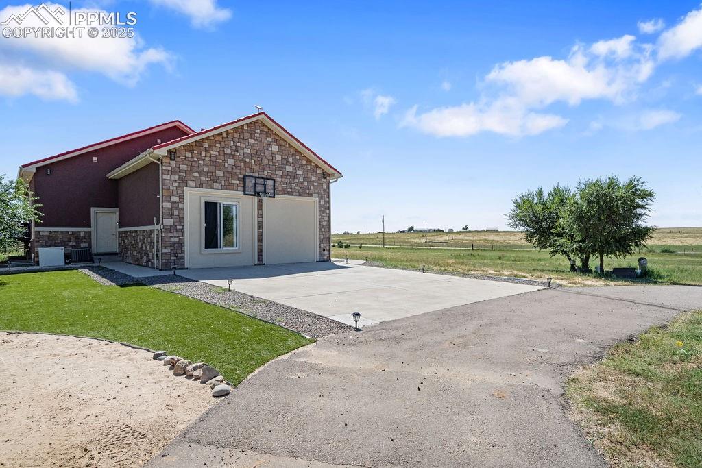 8450 Edison Road Yoder, CO 80864 - Photo 44 of 50 a view of a house with a yard and a large tree