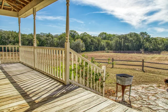 a view of a terrace with wooden floor and fence