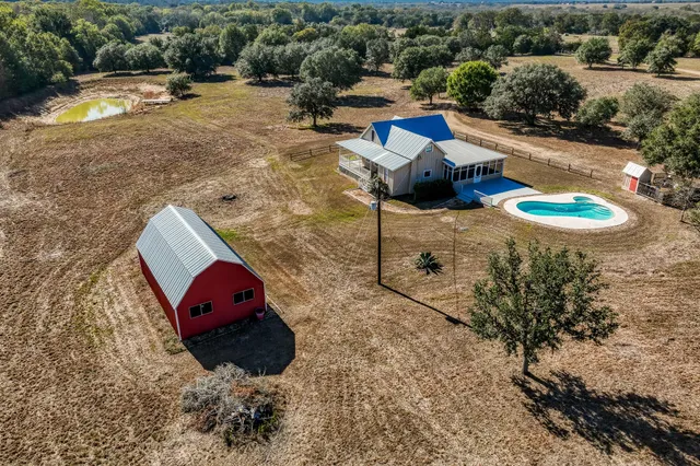 an aerial view of a house with outdoor space