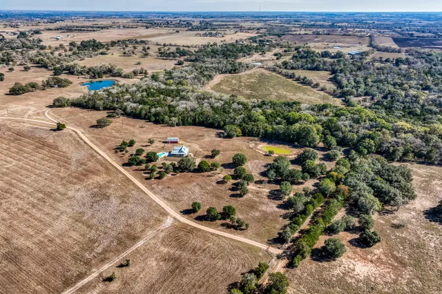 an aerial view of a house with a yard