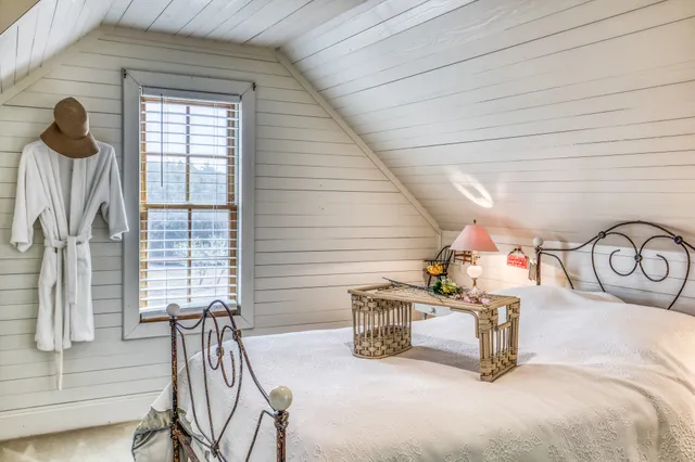 a bedroom with furniture and a window