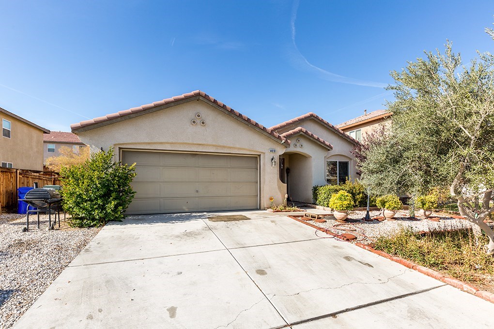 14810 Coachman Road Victorville, CA 92394 - Photo 1 of 1 a front view of a house with a yard